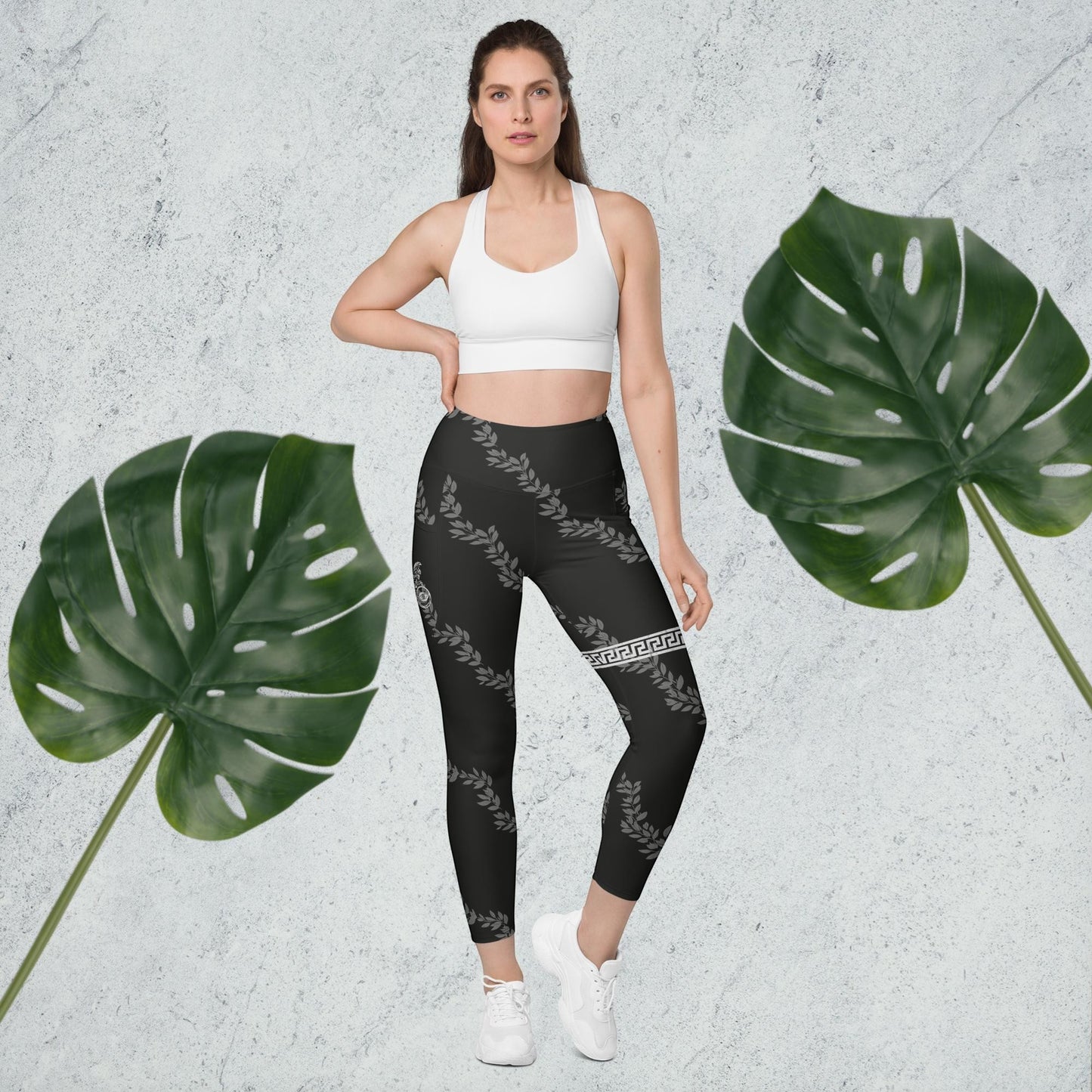 Immortal Krav Maga black high-waisted leggings with grey laurel leaf pattern and Greek key detail. Pockets on sides.
