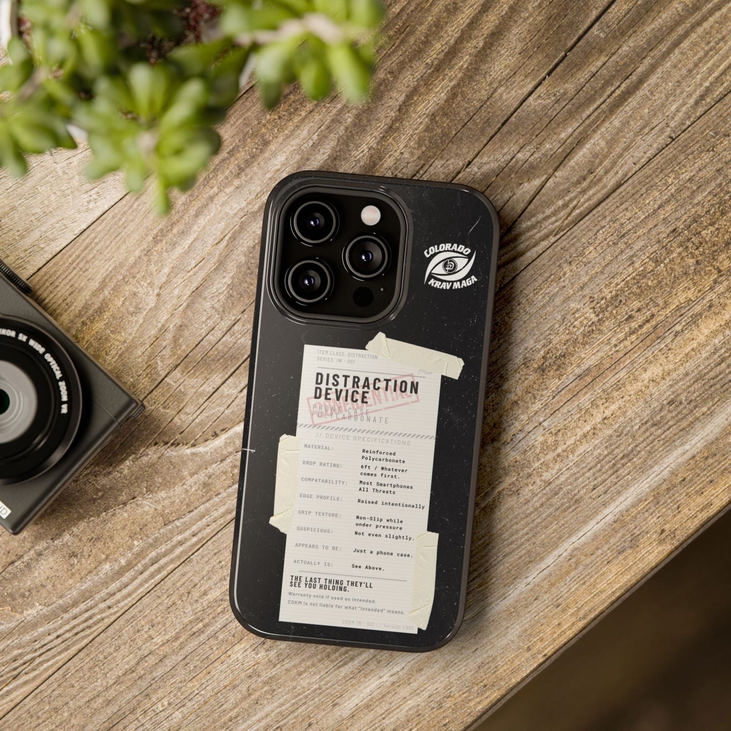 Immortal Krav Maga black polycarbonate phone case with "Distraction Device" label and tactical specs.