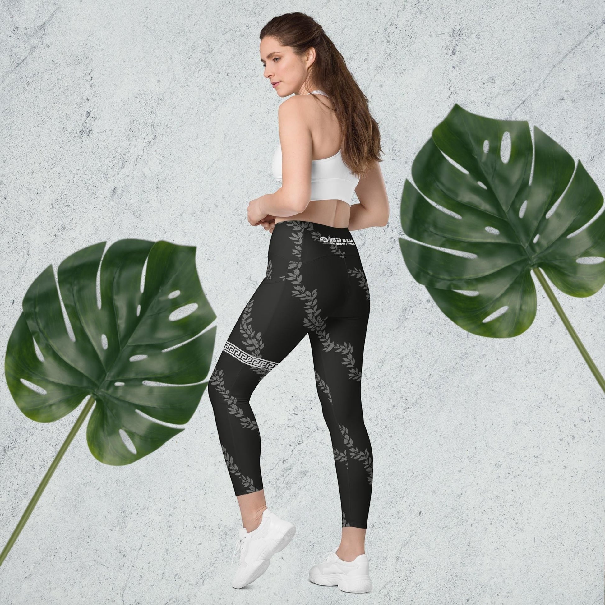 Immortal Krav Maga black high-waisted leggings with side pockets, featuring a laurel wreath and Greek key pattern.