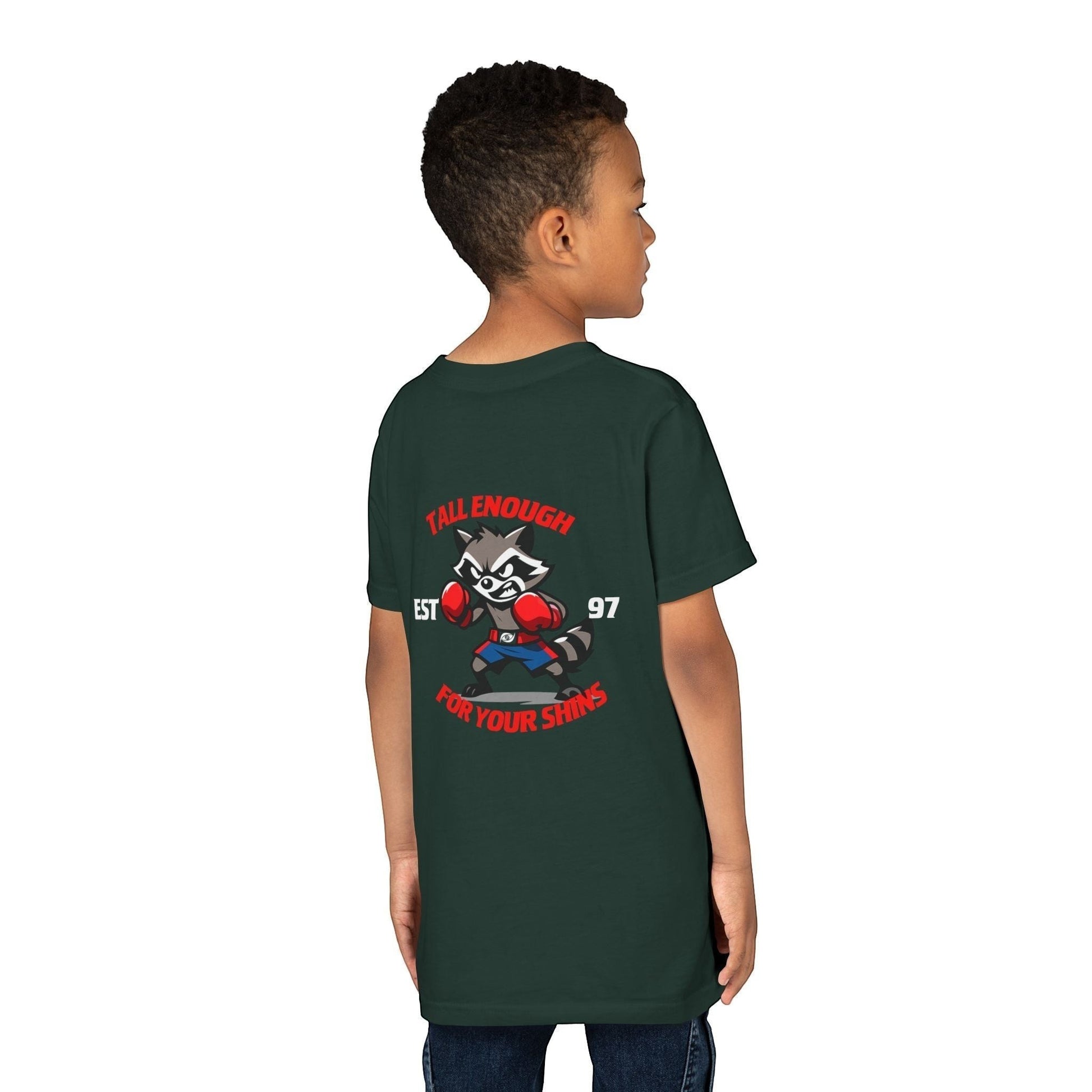 Immortal Krav Maga youth tee in dark green, 100% cotton, featuring a cartoon raccoon boxer graphic with text "TALL ENOUGH FOR YOUR SHINS"